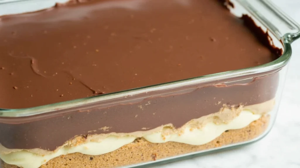 Chocolate Eclair Cake with Layers of Graham Crackers, Vanilla Pudding, and Chocolate Frosting